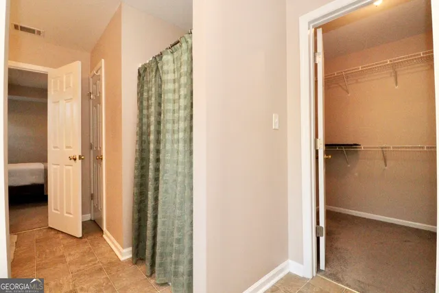 a view of a bathroom with a shower and a sink