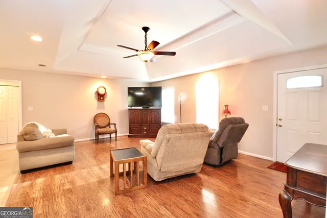 a living room with furniture and a wooden floor
