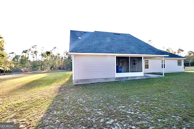 a view of a house with a backyard