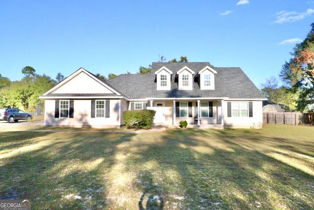 a front view of a house with a garden