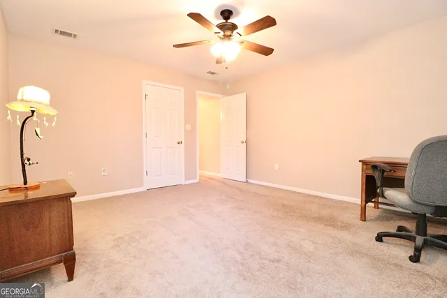 a view of a workspace with furniture and a chandelier