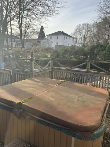 a view of a house with a wooden fence