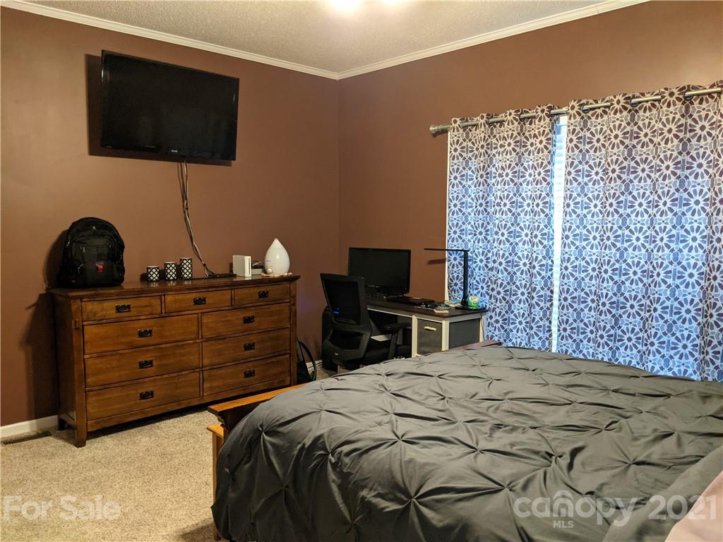 162 Robinson Creek Road Bostic, NC 28018 - Photo 15 of 35 a bedroom with a bed and a flat screen tv