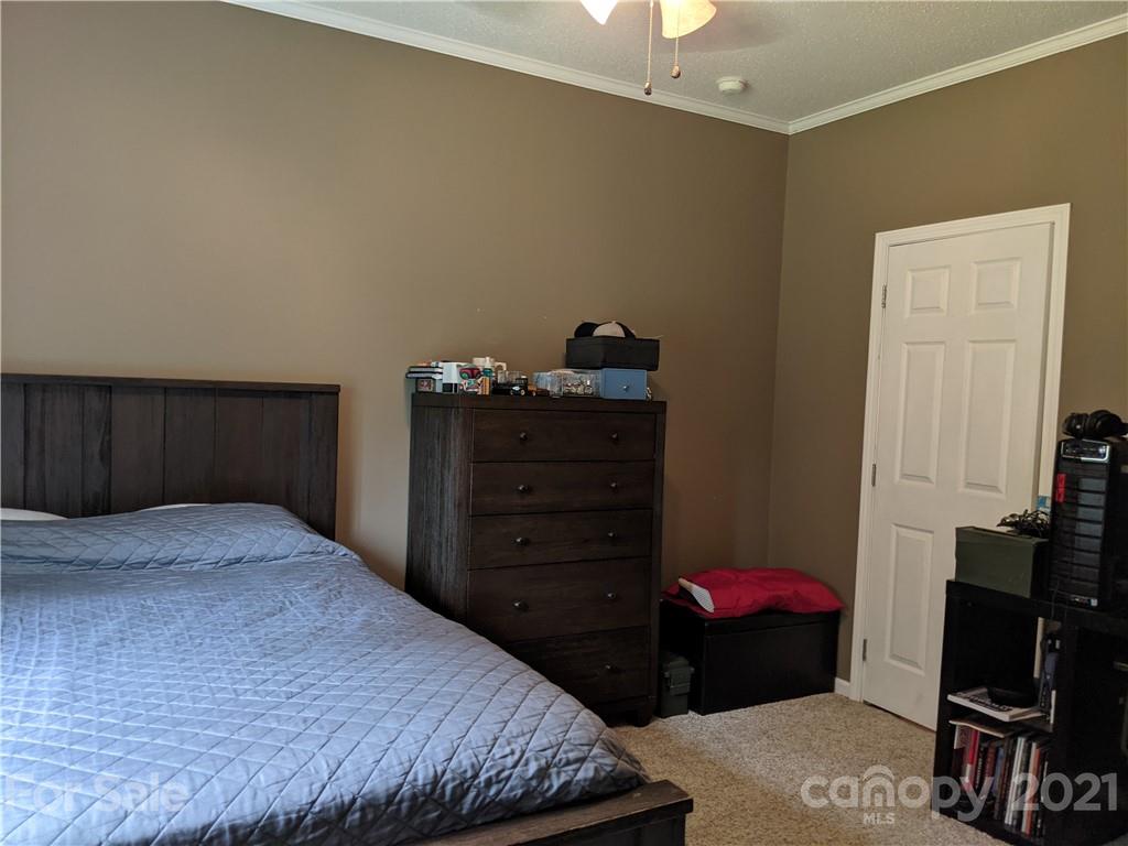 162 Robinson Creek Road Bostic, NC 28018 - Photo 22 of 35 a bedroom with a bed and a mirror
