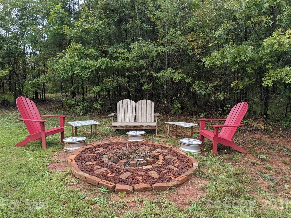 162 Robinson Creek Road Bostic, NC 28018 - Photo 28 of 35 a view of a chairs and fire pit in the backyard