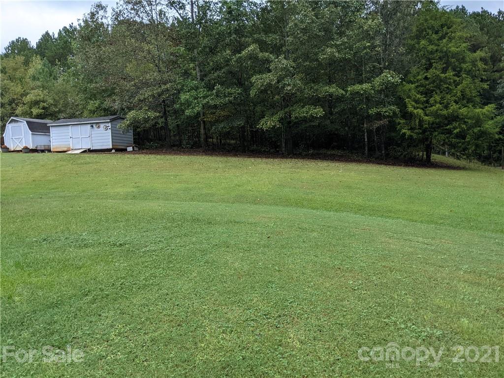 162 Robinson Creek Road Bostic, NC 28018 - Photo 30 of 35 a view of a backyard with a small cabin