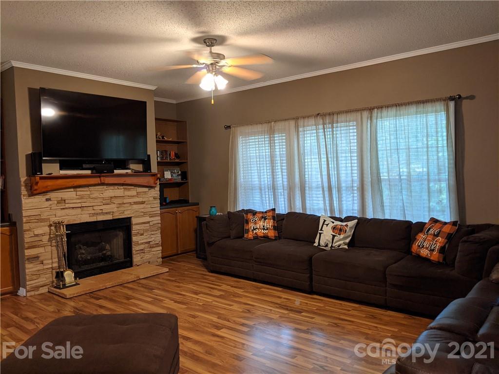 162 Robinson Creek Road Bostic, NC 28018 - Photo 5 of 35 a living room with furniture a flat screen tv and a fireplace