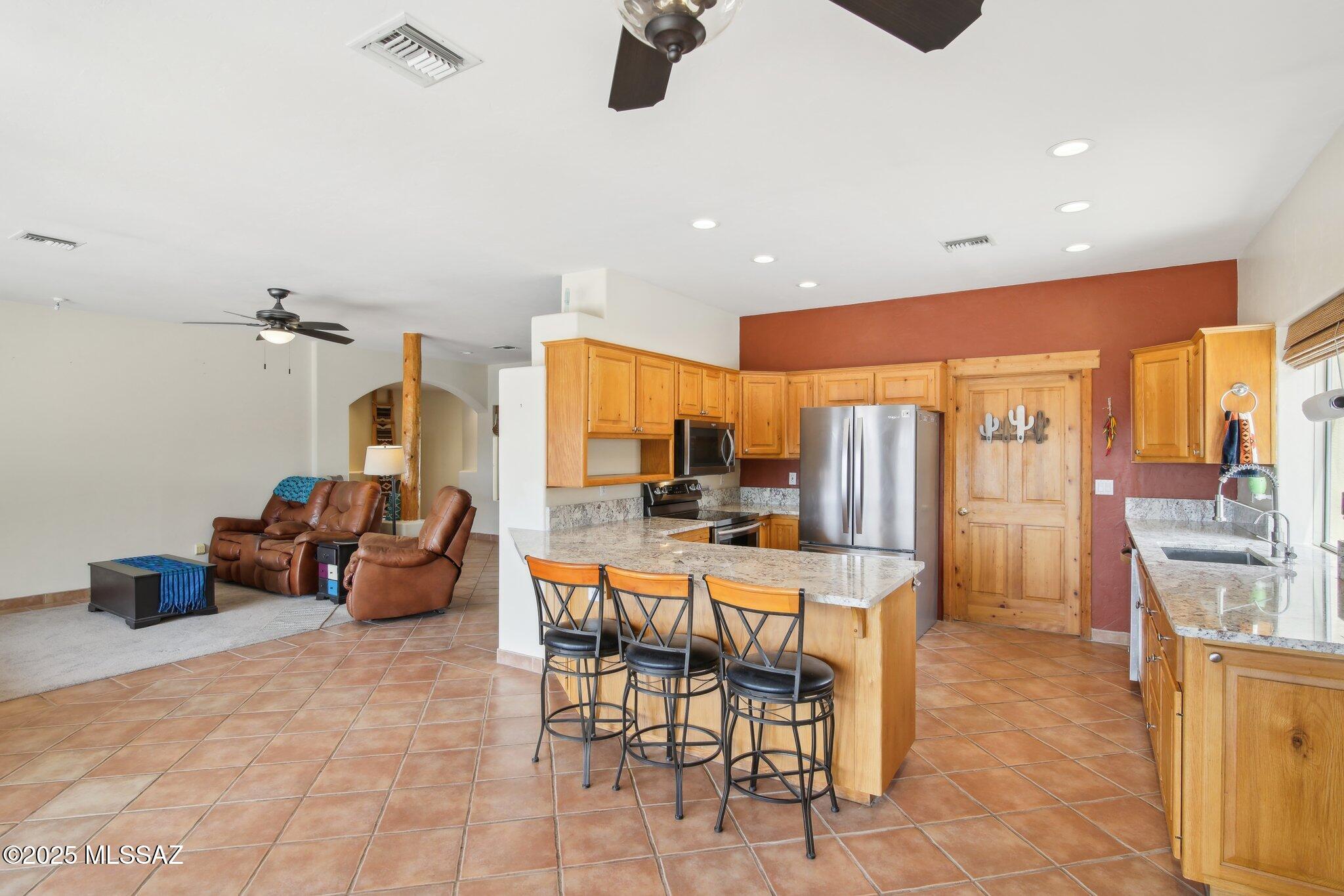 351 Camino Canoa Rio Rico, AZ 85648 - Photo 9 of 34 a large kitchen with a table and chairs