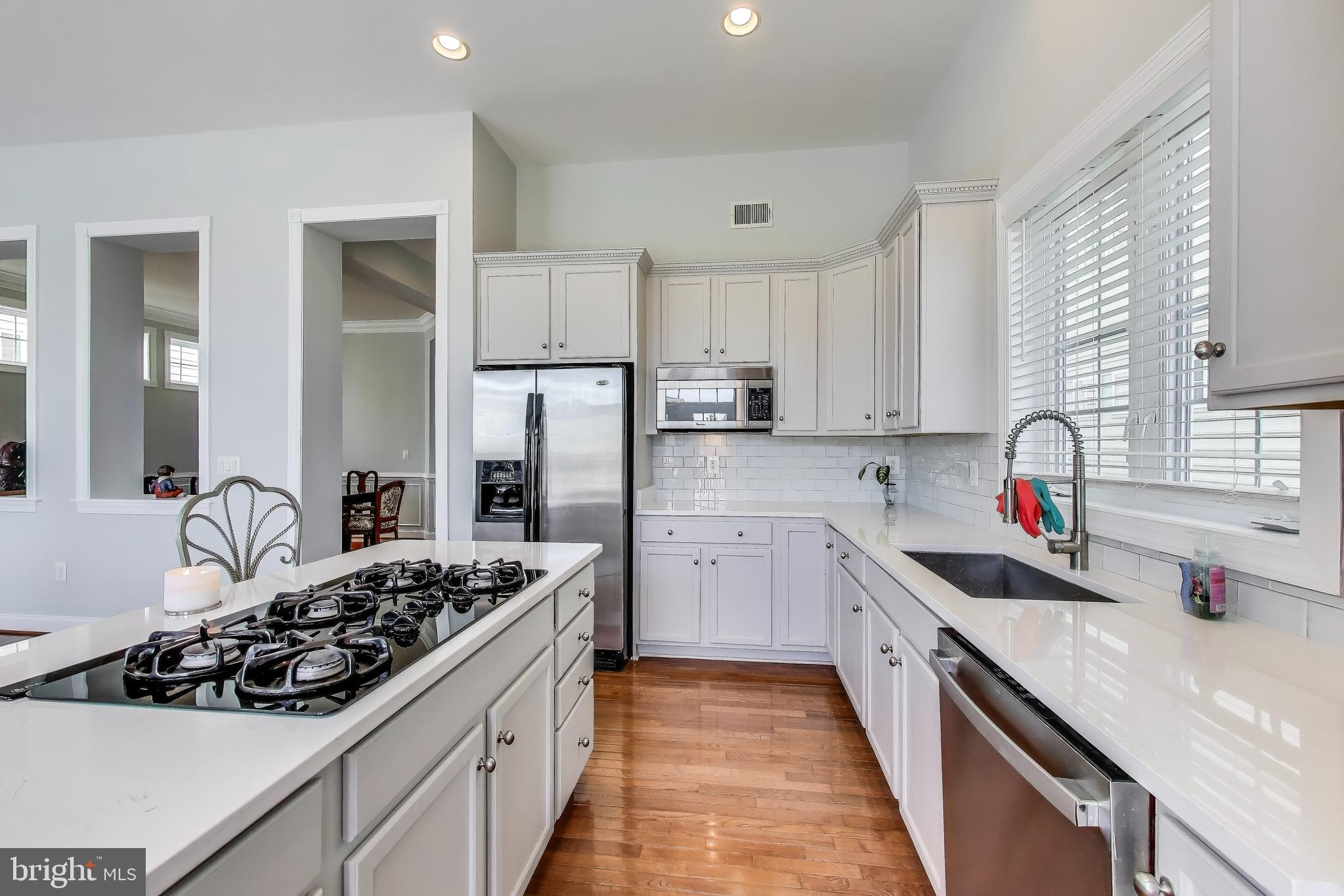 16180 Radburn Street Woodbridge, VA 22191 - Photo 11 of 54 a kitchen with kitchen island a sink stove and refrigerator