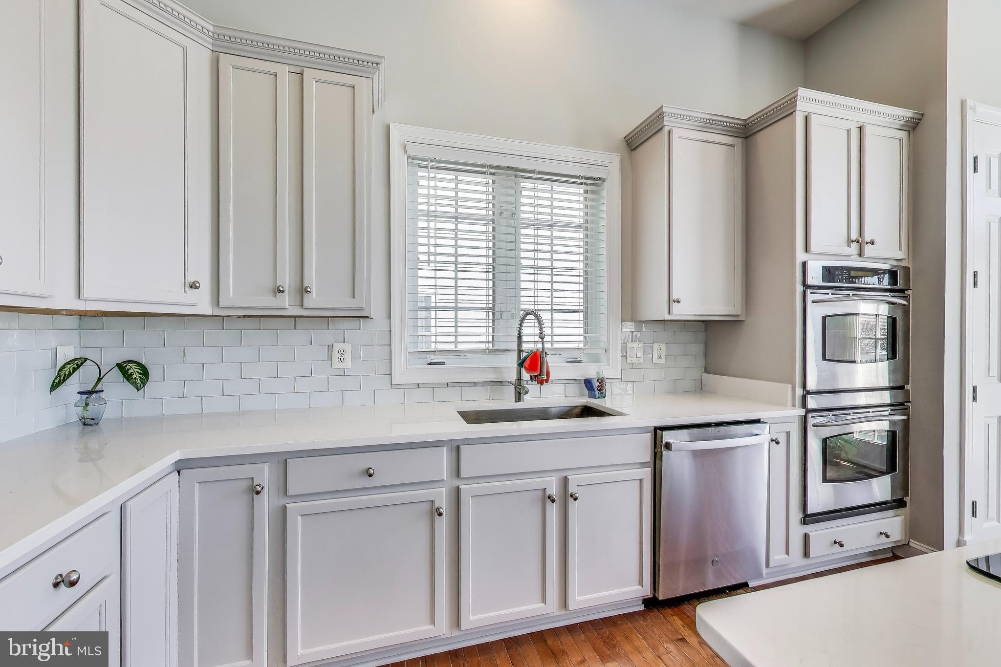16180 Radburn Street Woodbridge, VA 22191 - Photo 12 of 54 a kitchen with stainless steel appliances white cabinets and a window