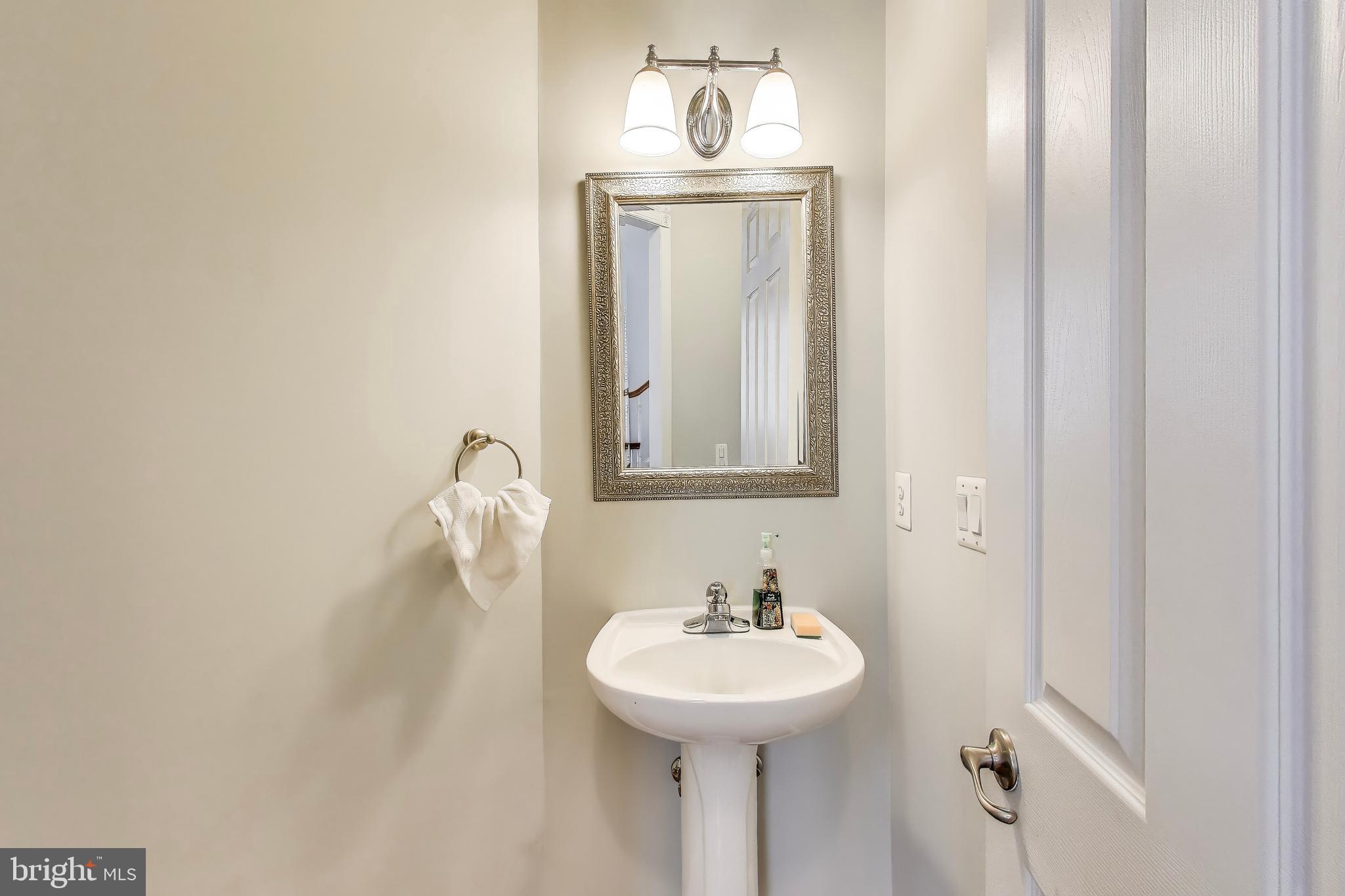 16180 Radburn Street Woodbridge, VA 22191 - Photo 18 of 54 a bathroom with a sink a mirror and vanity