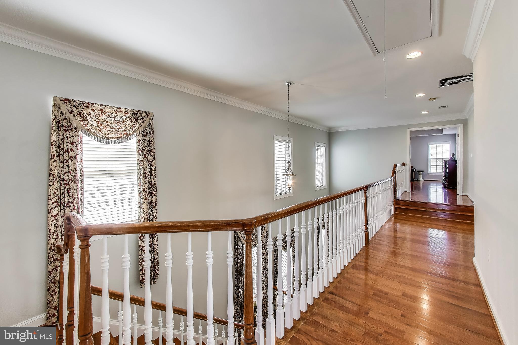 16180 Radburn Street Woodbridge, VA 22191 - Photo 19 of 54 a view of a hallway with wooden floor and windows