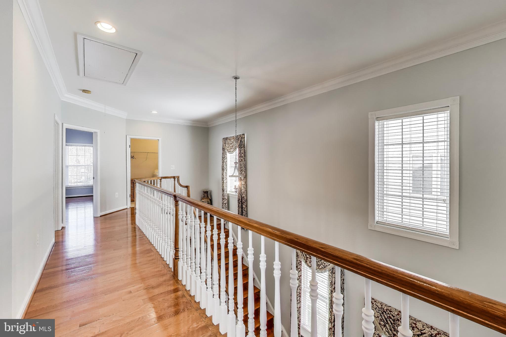 16180 Radburn Street Woodbridge, VA 22191 - Photo 20 of 54 a view of a hallway with wooden floor and windows