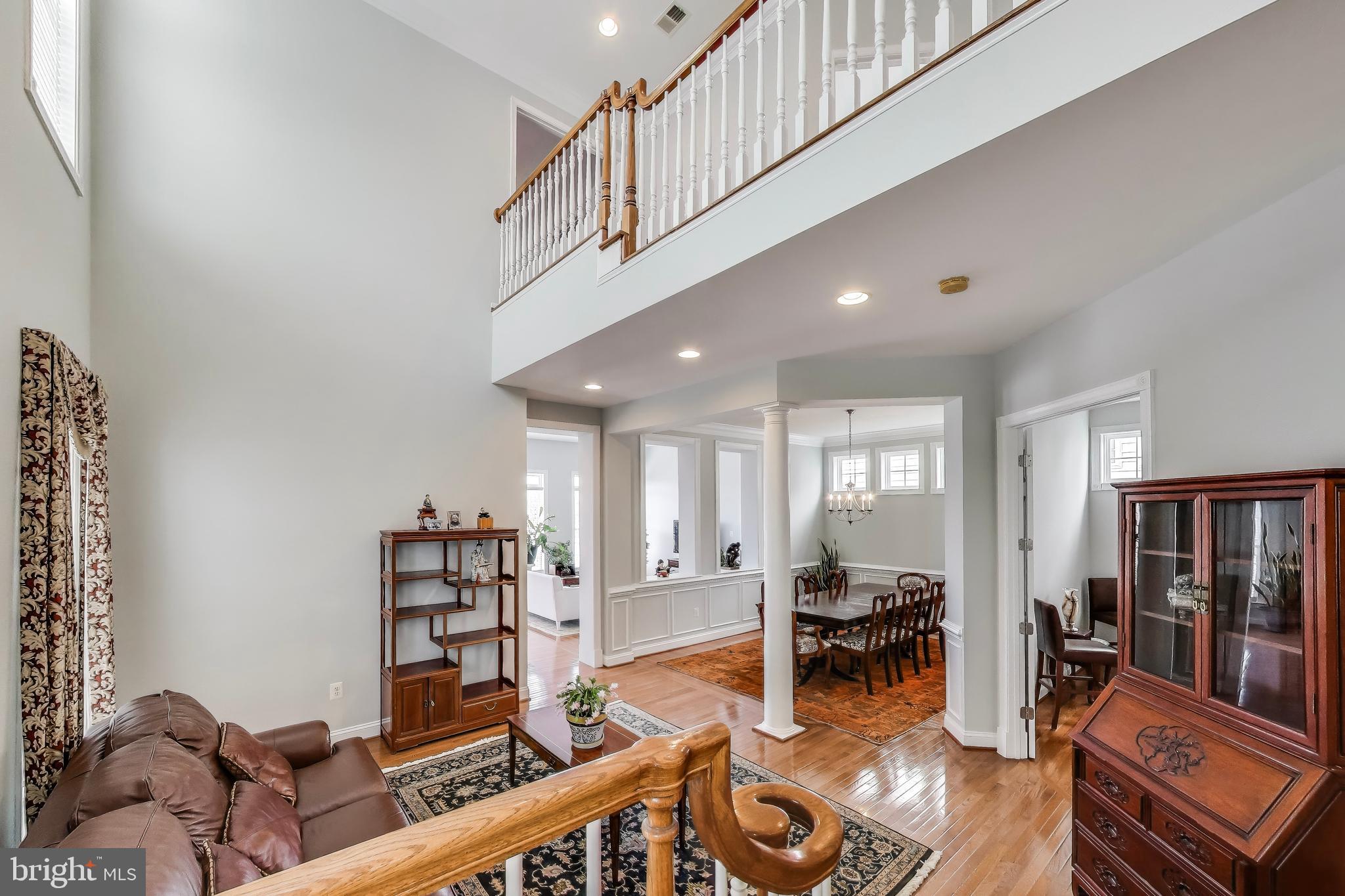 16180 Radburn Street Woodbridge, VA 22191 - Photo 21 of 54 a living room with furniture stairs and a large window