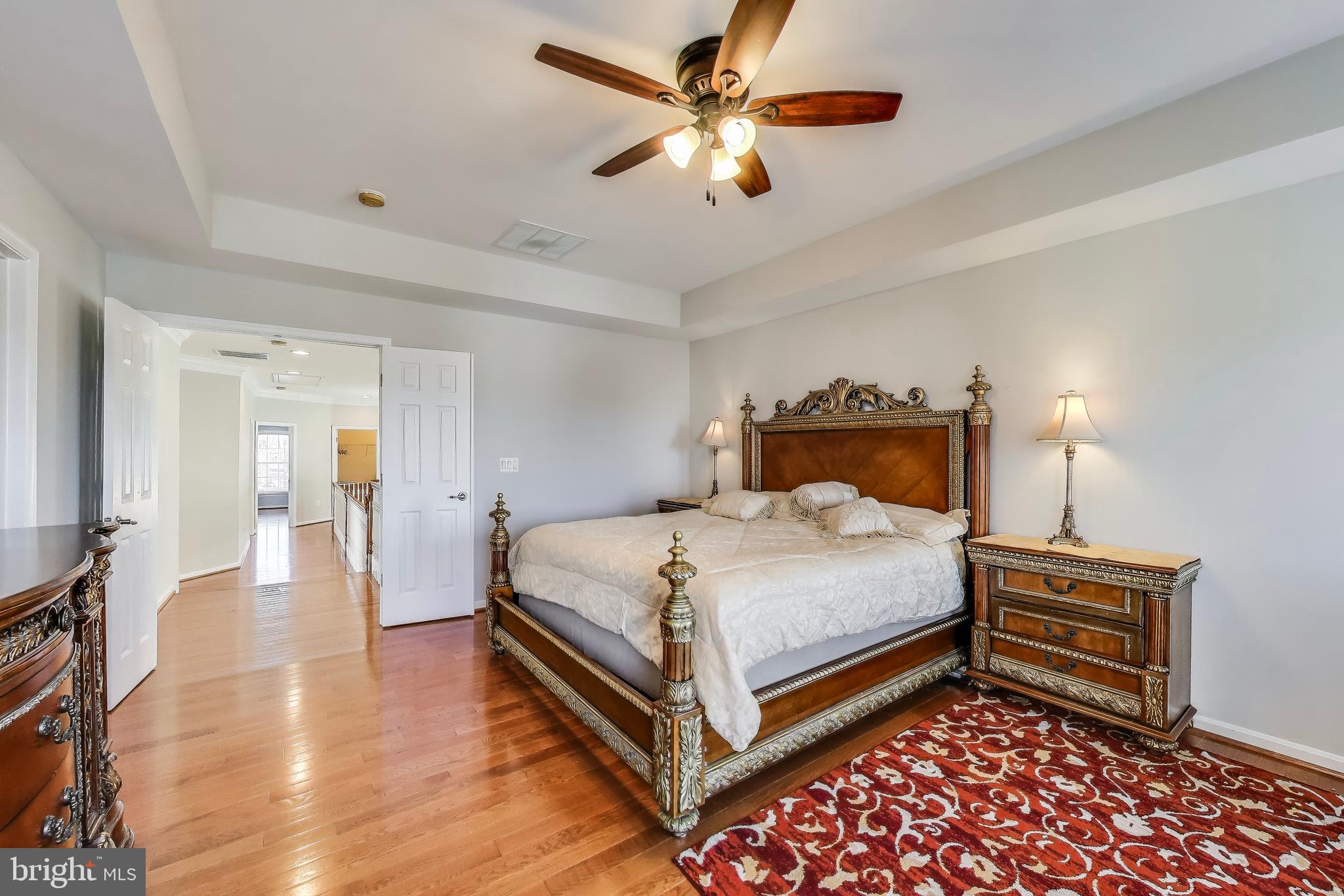 16180 Radburn Street Woodbridge, VA 22191 - Photo 23 of 54 a bedroom with a bed and a chandelier