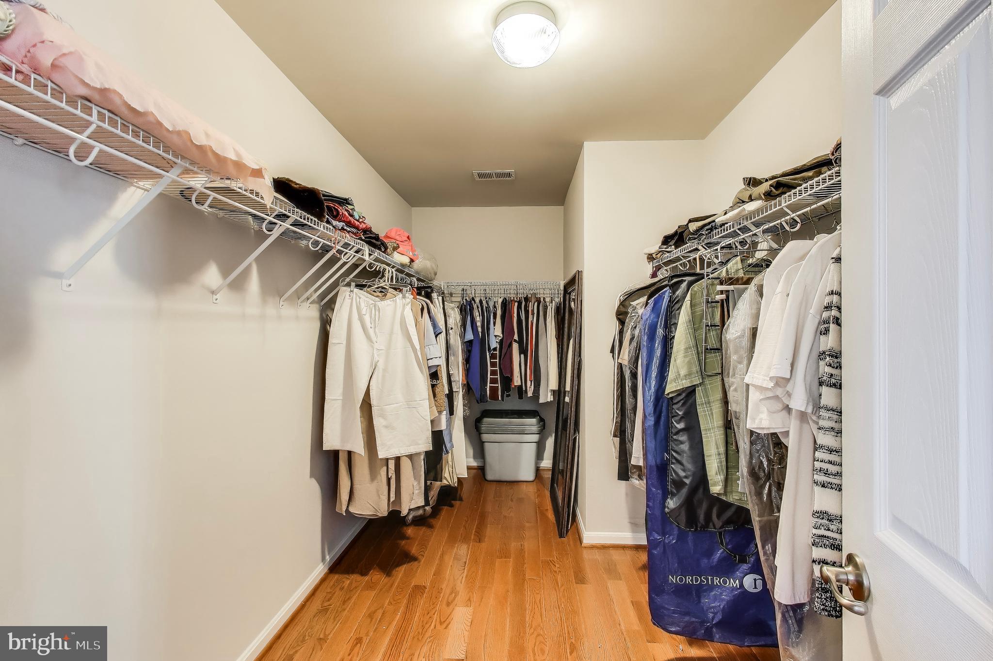 16180 Radburn Street Woodbridge, VA 22191 - Photo 25 of 54 a view of walk in closet with clothes and shoes