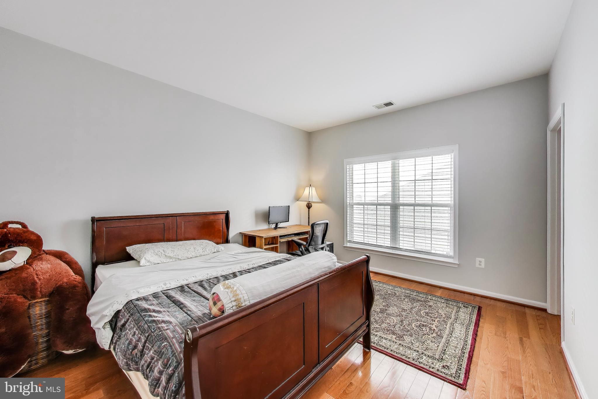 16180 Radburn Street Woodbridge, VA 22191 - Photo 28 of 54 a bed sitting in a bedroom next to a window
