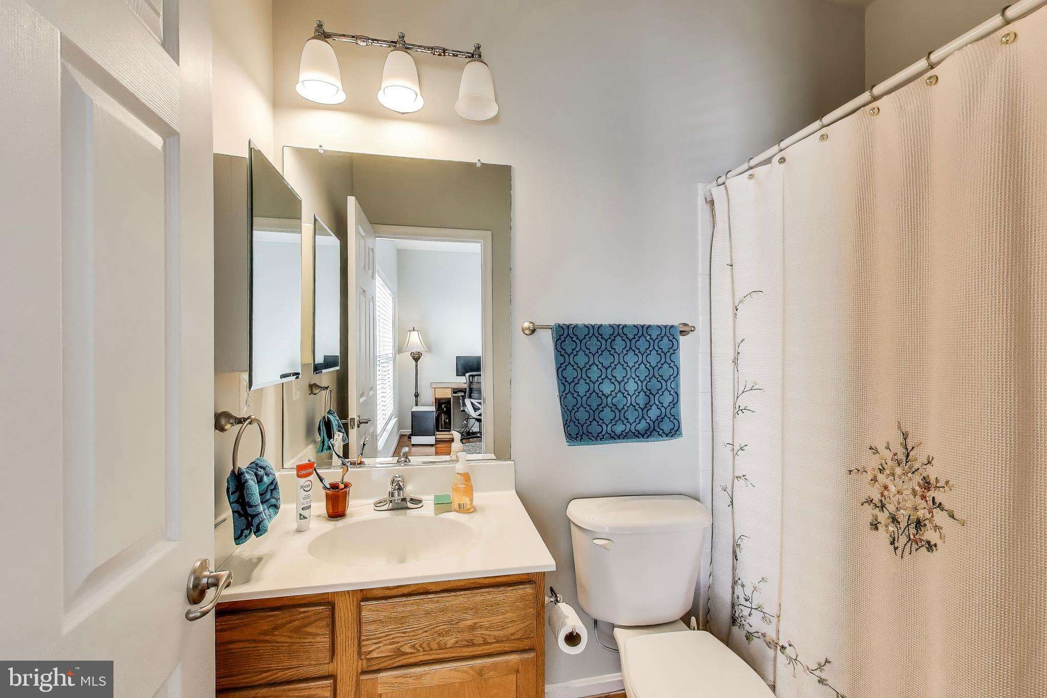 16180 Radburn Street Woodbridge, VA 22191 - Photo 31 of 54 a bathroom with a sink toilet and shower