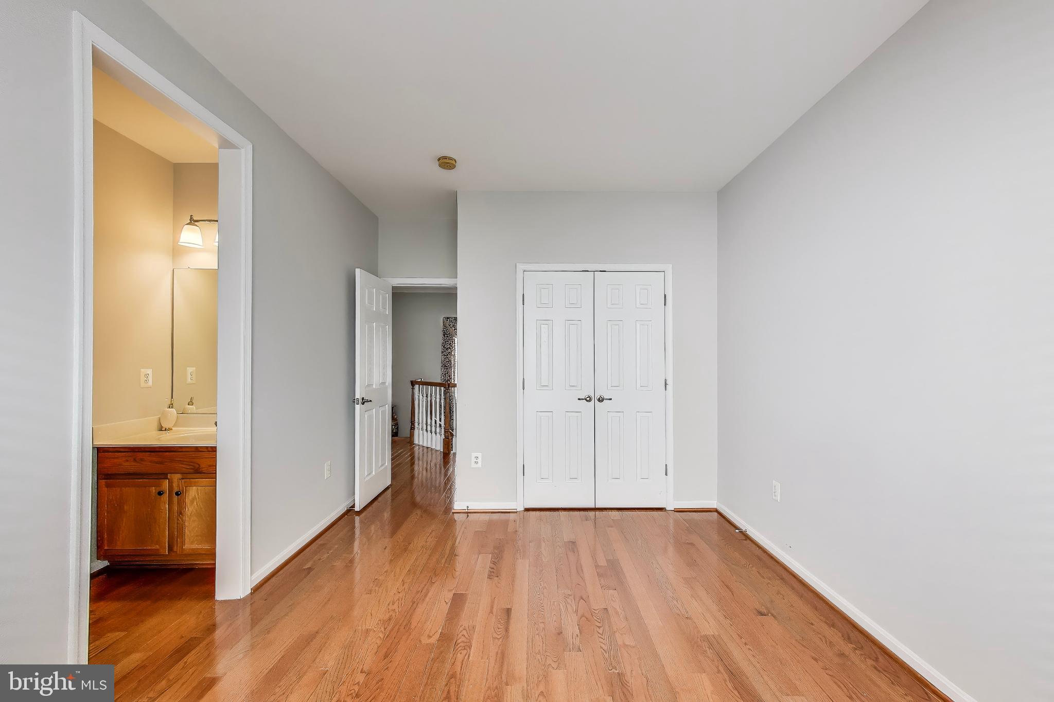 16180 Radburn Street Woodbridge, VA 22191 - Photo 33 of 54 a view of a room with wooden floor and a bathroom