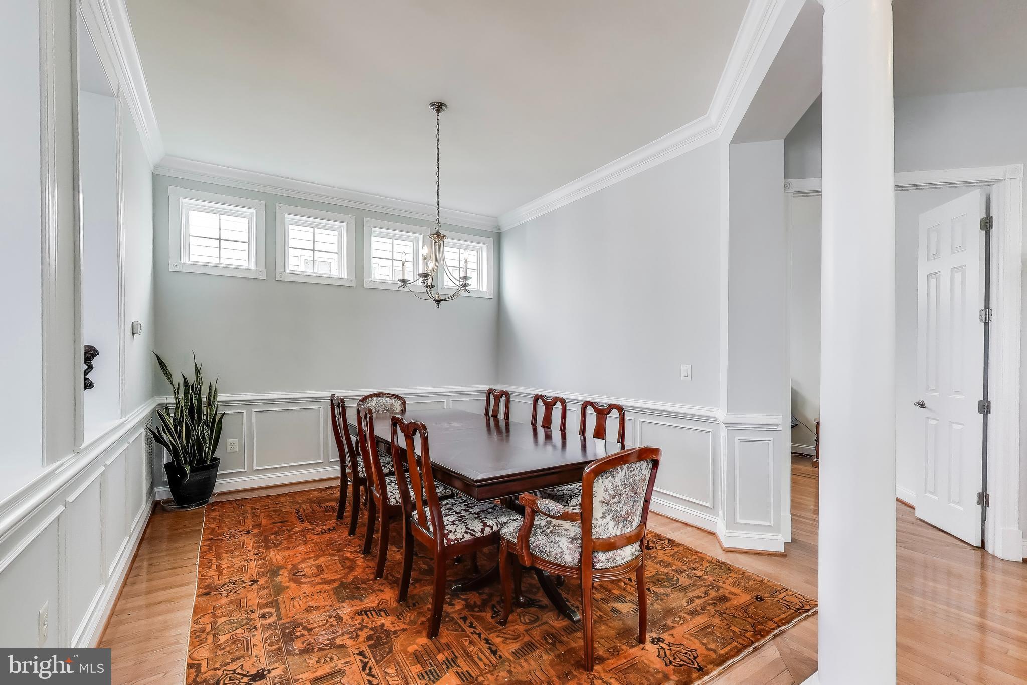 16180 Radburn Street Woodbridge, VA 22191 - Photo 8 of 54 a view of a dining room with furniture window and wooden floor