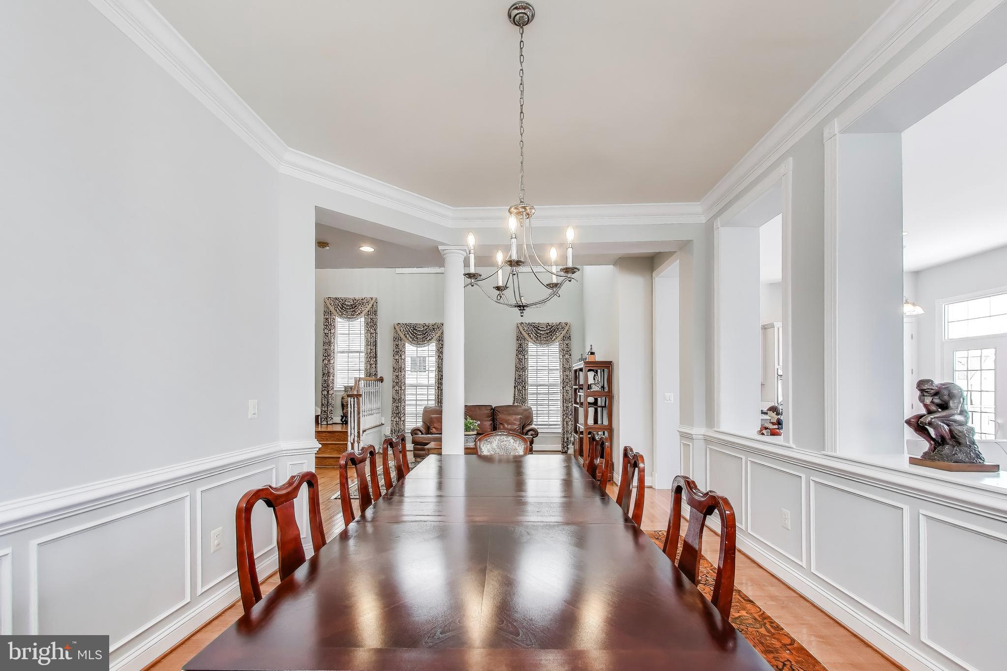 16180 Radburn Street Woodbridge, VA 22191 - Photo 9 of 54 a hallway with wooden floor chandelier and windows