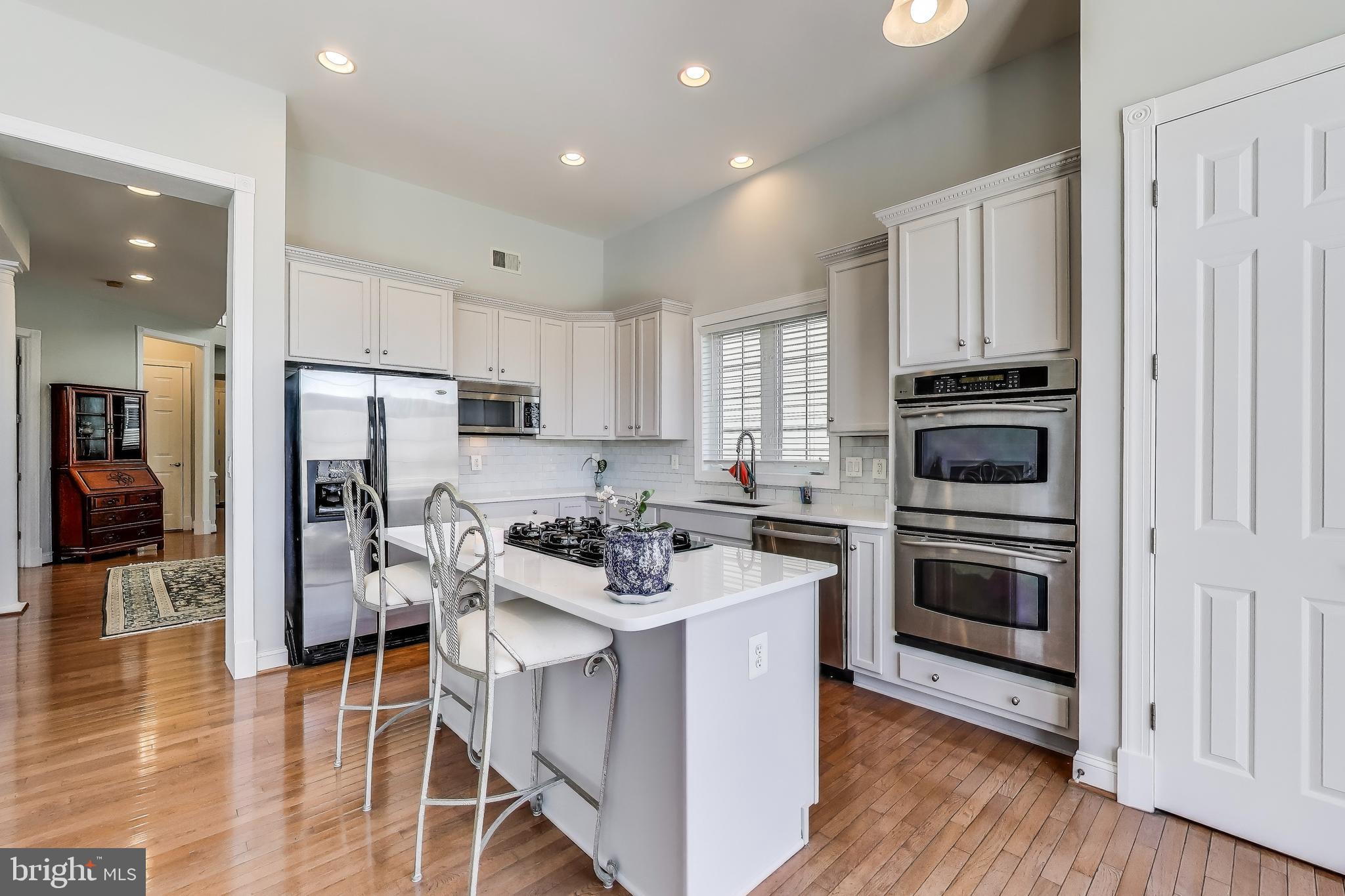 16180 Radburn Street Woodbridge, VA 22191 - Photo 10 of 54 a kitchen with cabinets and stainless steel appliances