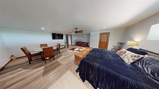 a bedroom with furniture and a wooden floor