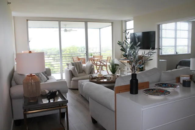 a living room with furniture and flat screen tv