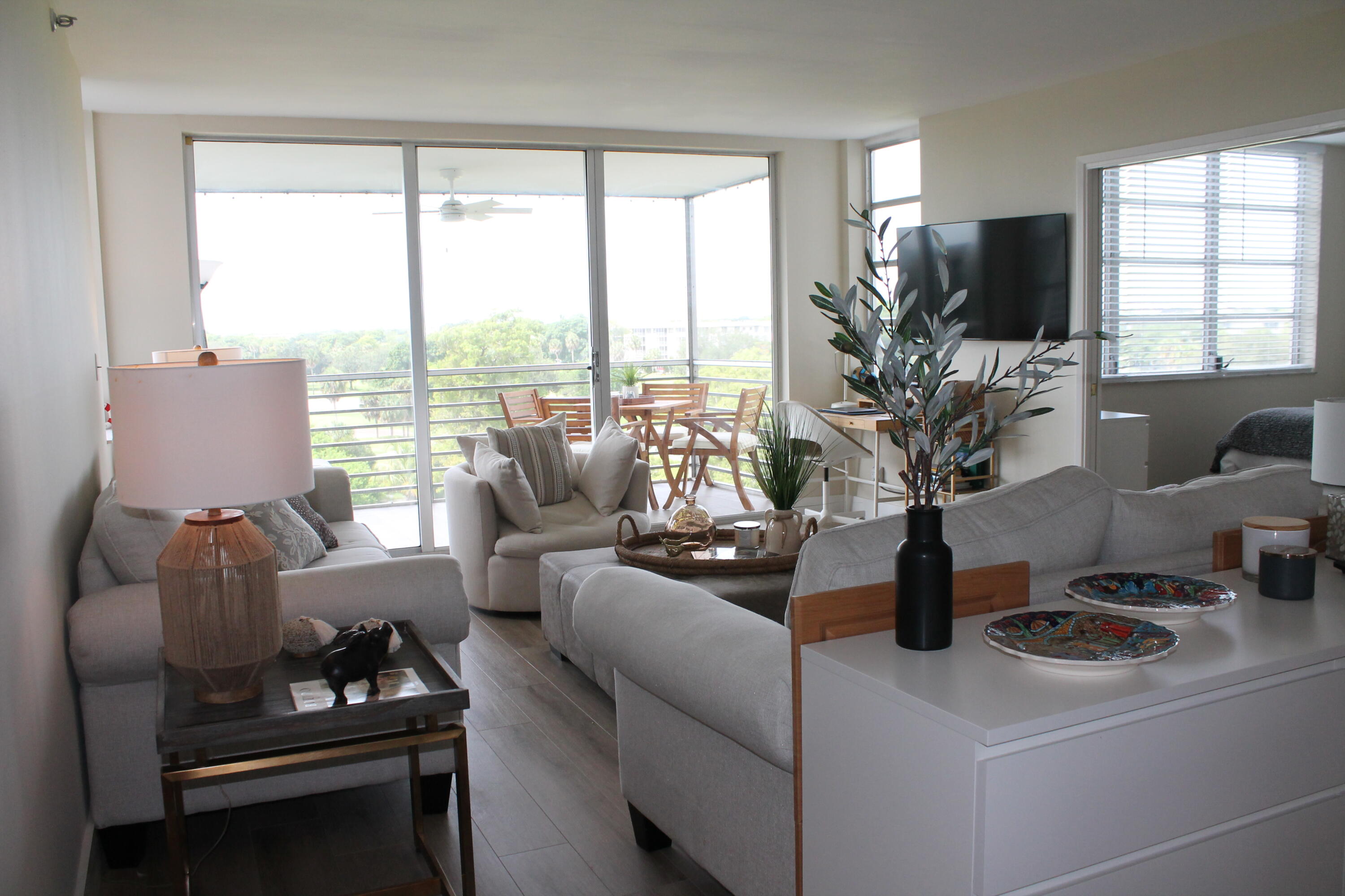 3520 Oaks Way, Unit 607 Pompano Beach, FL 33069 - Photo 11 of 46 a living room with furniture and flat screen tv