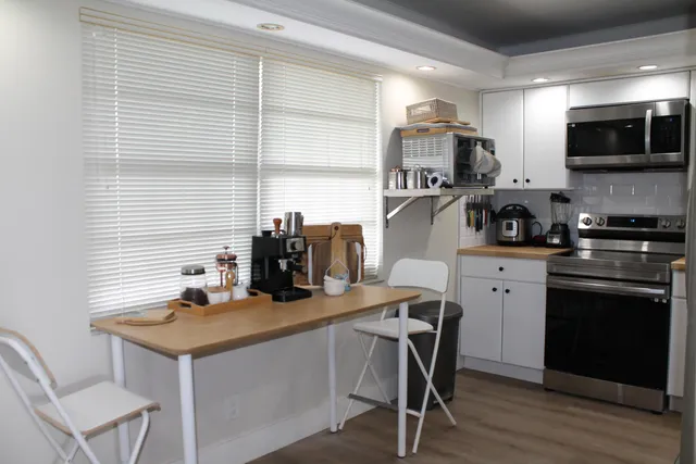 a kitchen with a stove a sink and a microwave