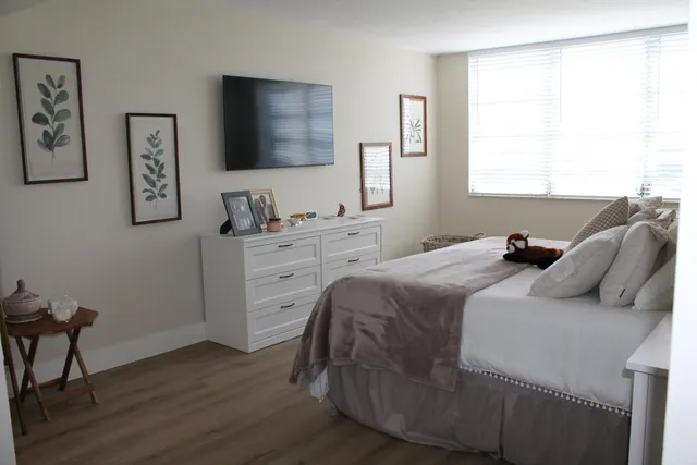 a bedroom with a bed and a flat screen tv