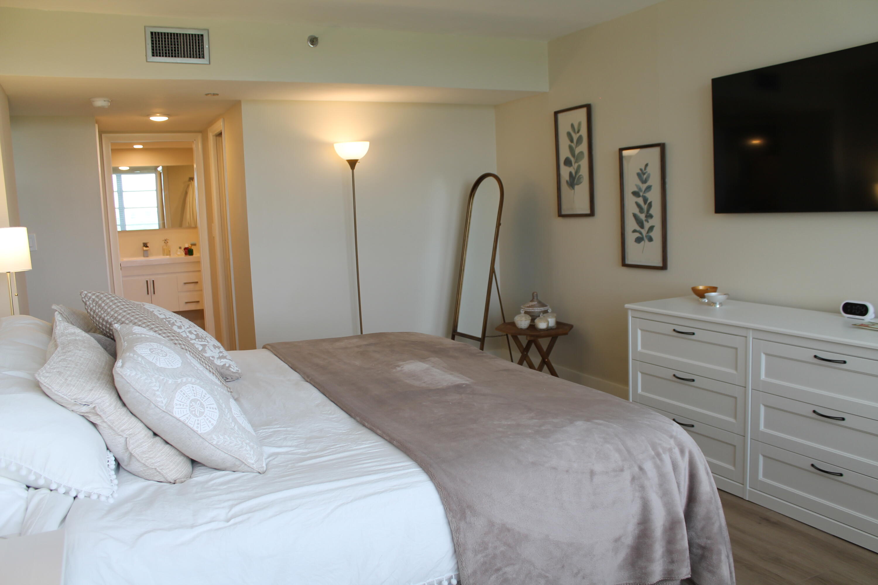 3520 Oaks Way, Unit 607 Pompano Beach, FL 33069 - Photo 21 of 46 a bedroom with a bed and a flat screen tv