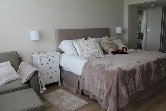 a bedroom with a bed and a dresser