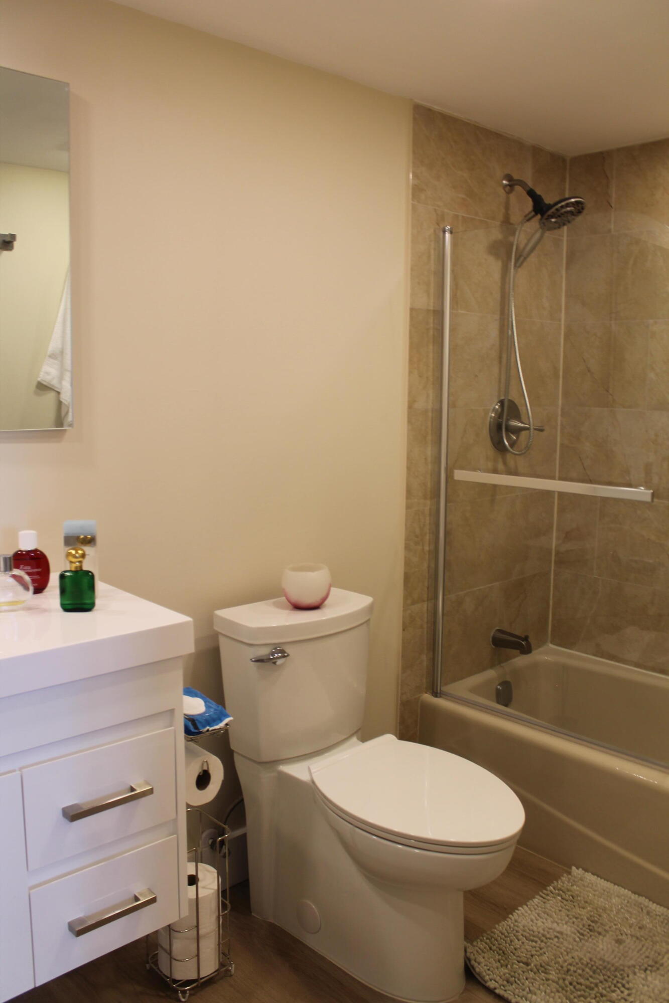 3520 Oaks Way, Unit 607 Pompano Beach, FL 33069 - Photo 26 of 46 a bathroom with a sink a toilet and shower