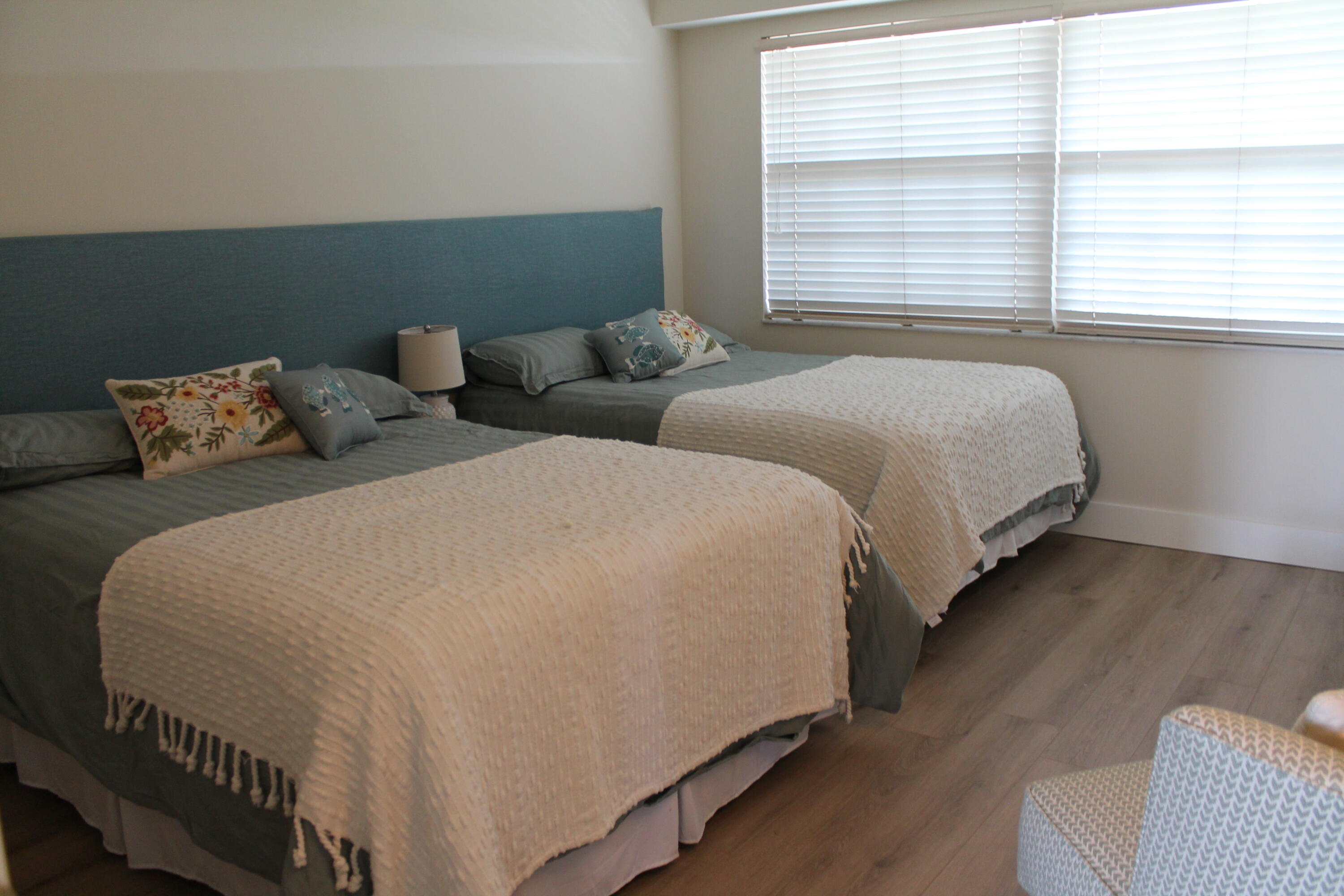 3520 Oaks Way, Unit 607 Pompano Beach, FL 33069 - Photo 27 of 46 a bedroom with two beds and a window