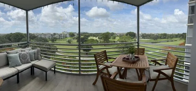 a view of a balcony with chairs and a table