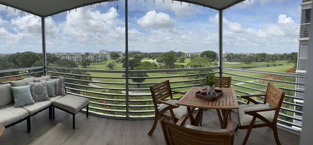 3520 Oaks Way, Unit 607 Pompano Beach, FL 33069 - Photo 30 of 46 a view of a chairs and table in the balcony