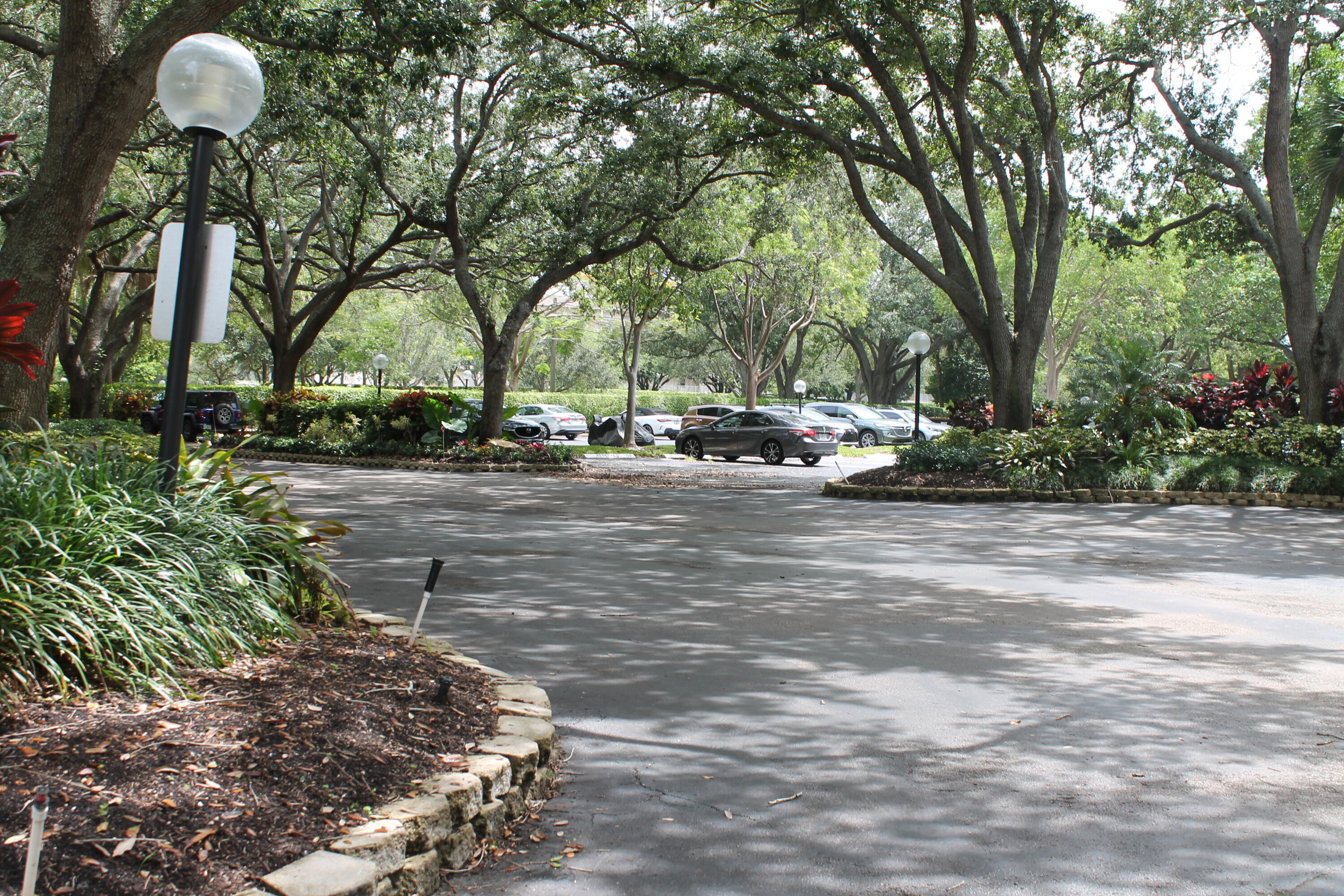 3520 Oaks Way, Unit 607 Pompano Beach, FL 33069 - Photo 3 of 46 a view of a park with large trees