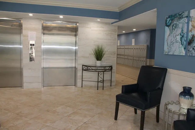 a view of swimming pool with lawn chairs and plants