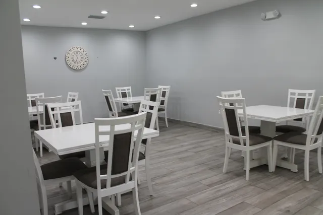 a bathroom with a granite countertop shower a sink and a mirror
