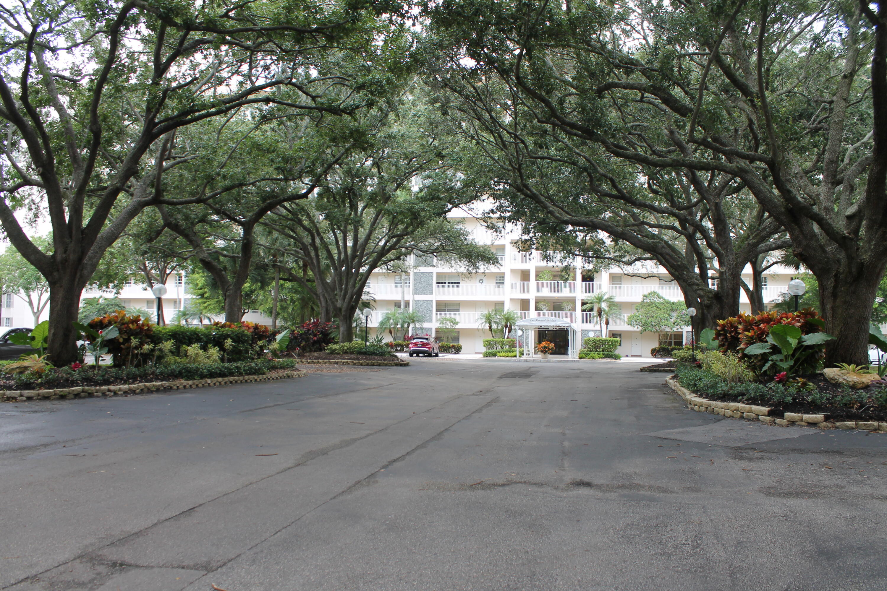 3520 Oaks Way, Unit 607 Pompano Beach, FL 33069 - Photo 46 of 46 a view of a house with a road and trees