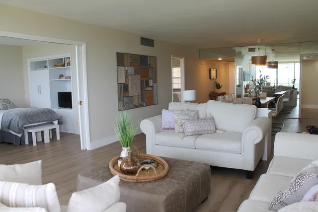 a living room with furniture and a wooden floor