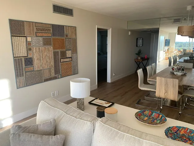 a living room with furniture and a potted plant