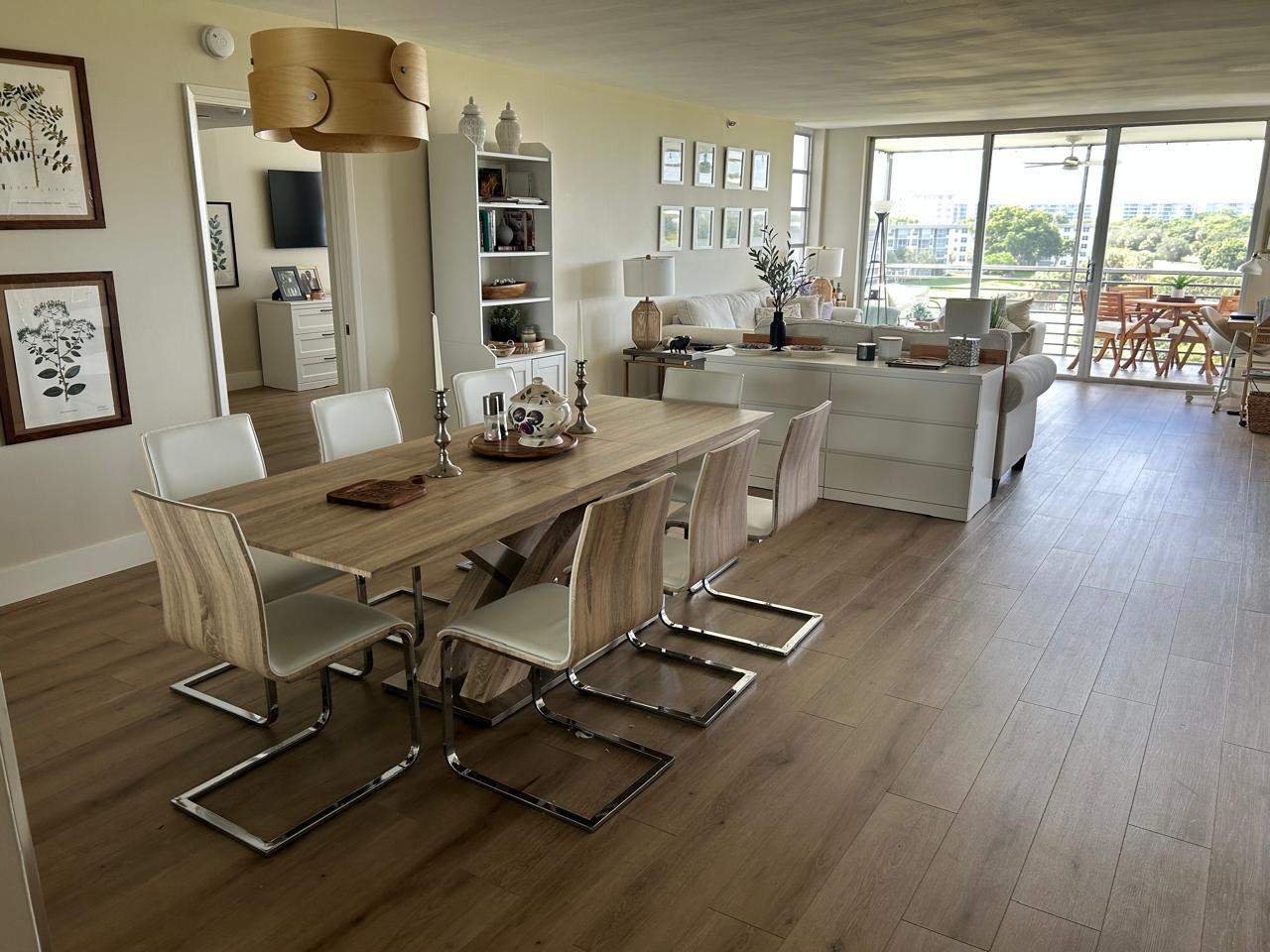 3520 Oaks Way, Unit 607 Pompano Beach, FL 33069 - Photo 7 of 46 a view of a dining room with furniture window and wooden floor