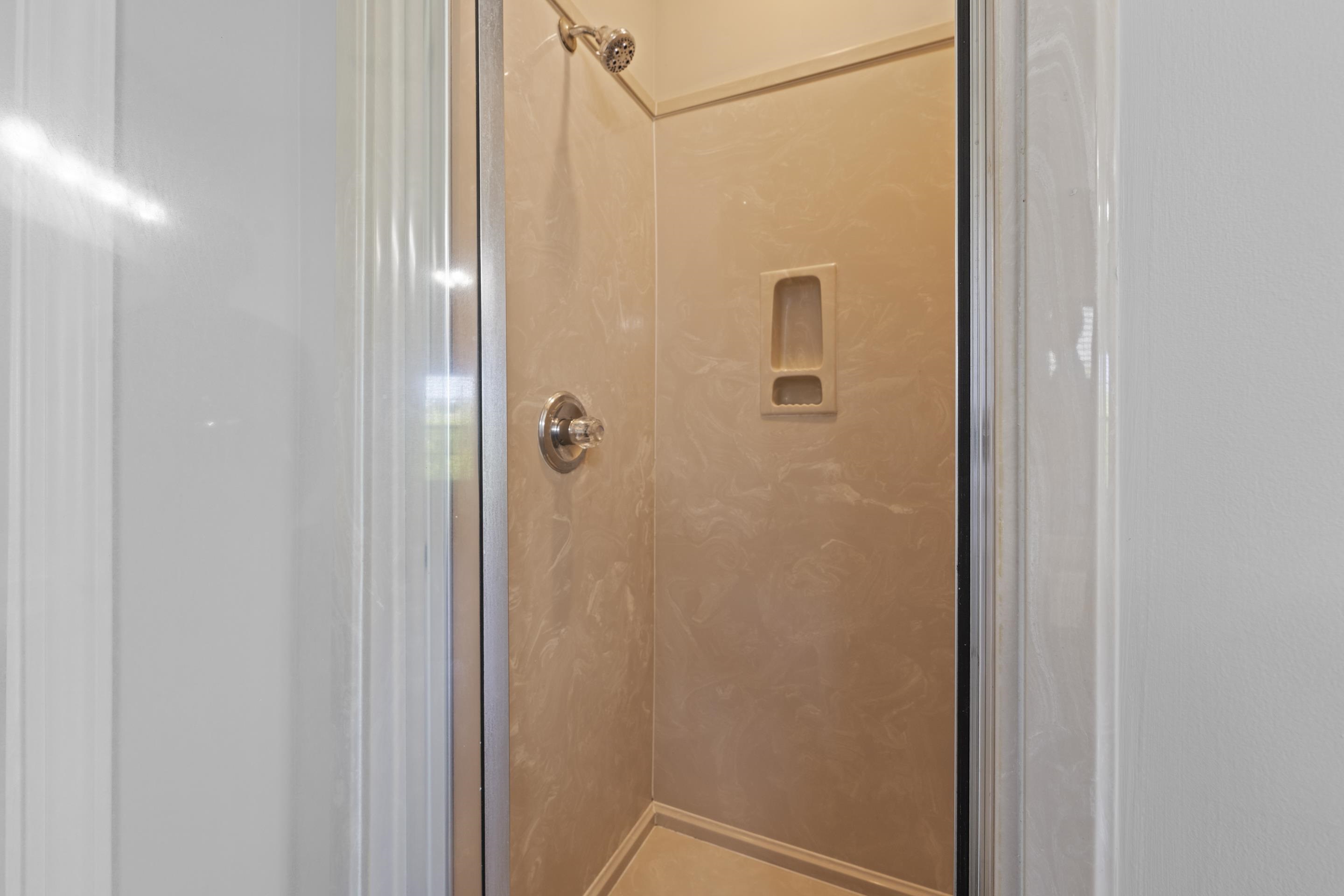 50 Abbey Road Oakland, TN 38060 - Photo 18 of 26 Enclosed shower stall with a clear glass door, chrome fixtures, and a built-in shower niche