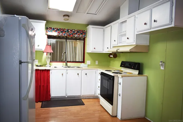 a utility room with cabinets washer and dryer