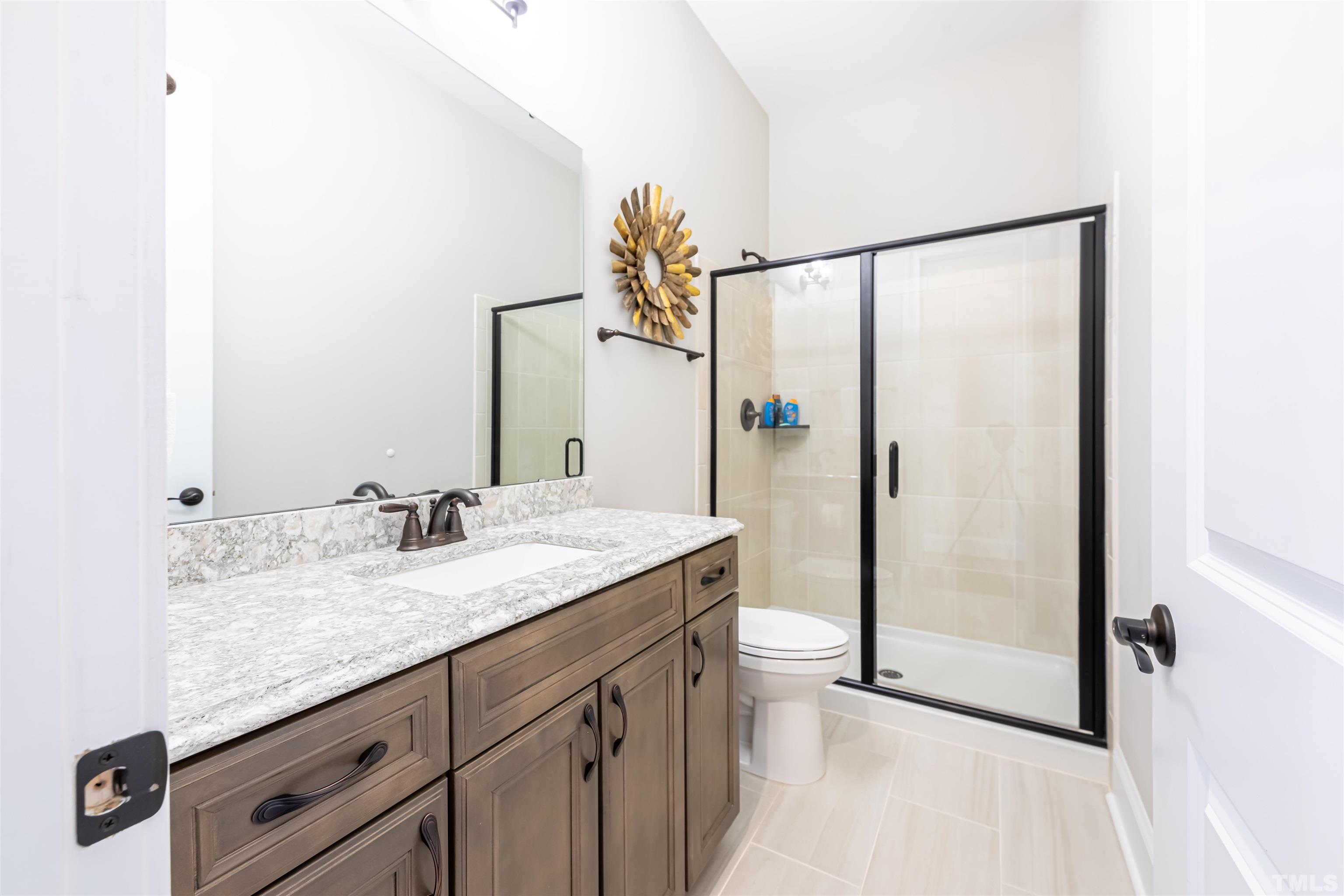 456 Adkins Ridge Road Rolesville, NC 27571 - Photo 12 of 38 a bathroom with a granite countertop sink and a mirror