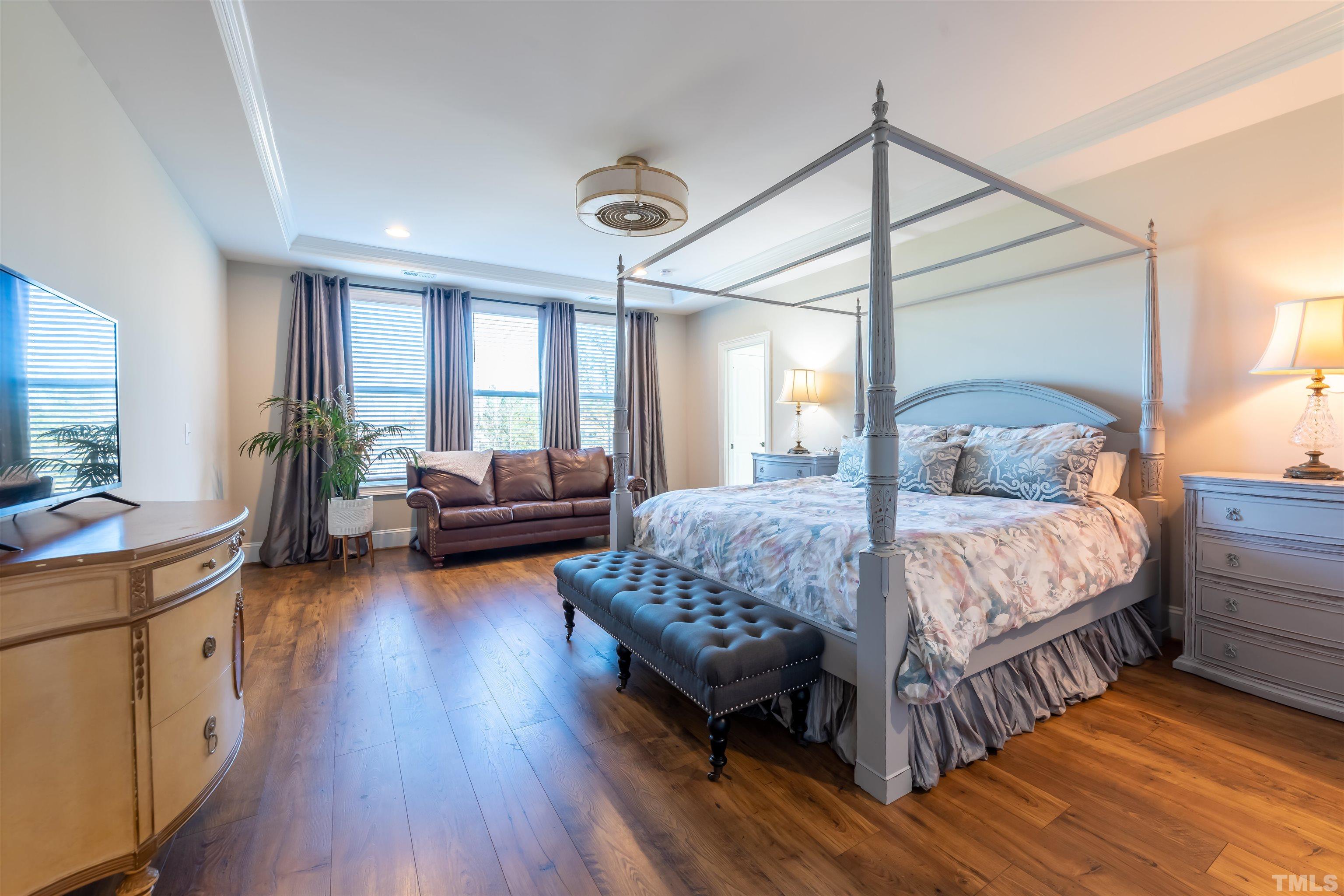456 Adkins Ridge Road Rolesville, NC 27571 - Photo 14 of 38 a bedroom with a bed and a large window