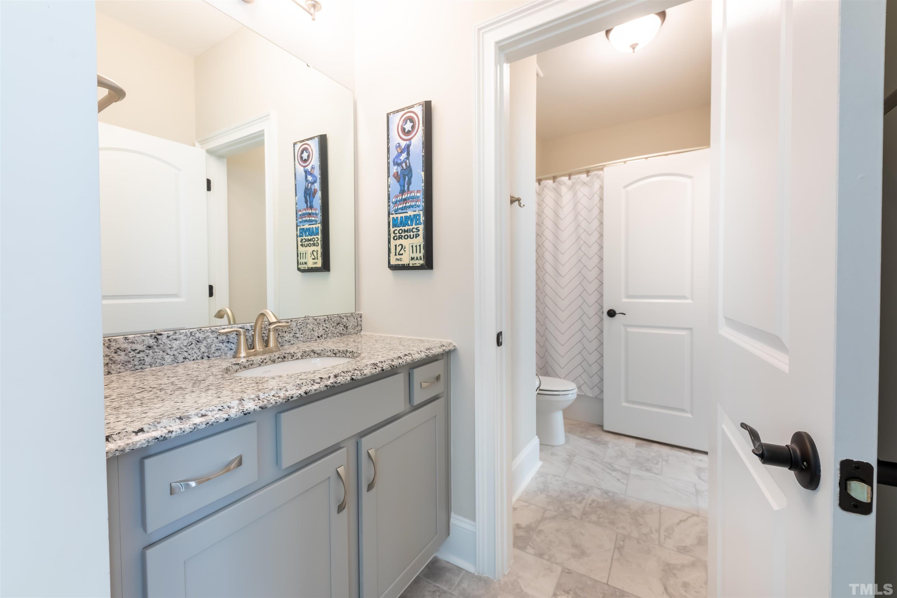 456 Adkins Ridge Road Rolesville, NC 27571 - Photo 21 of 38 a bathroom with a granite countertop sink and a mirror