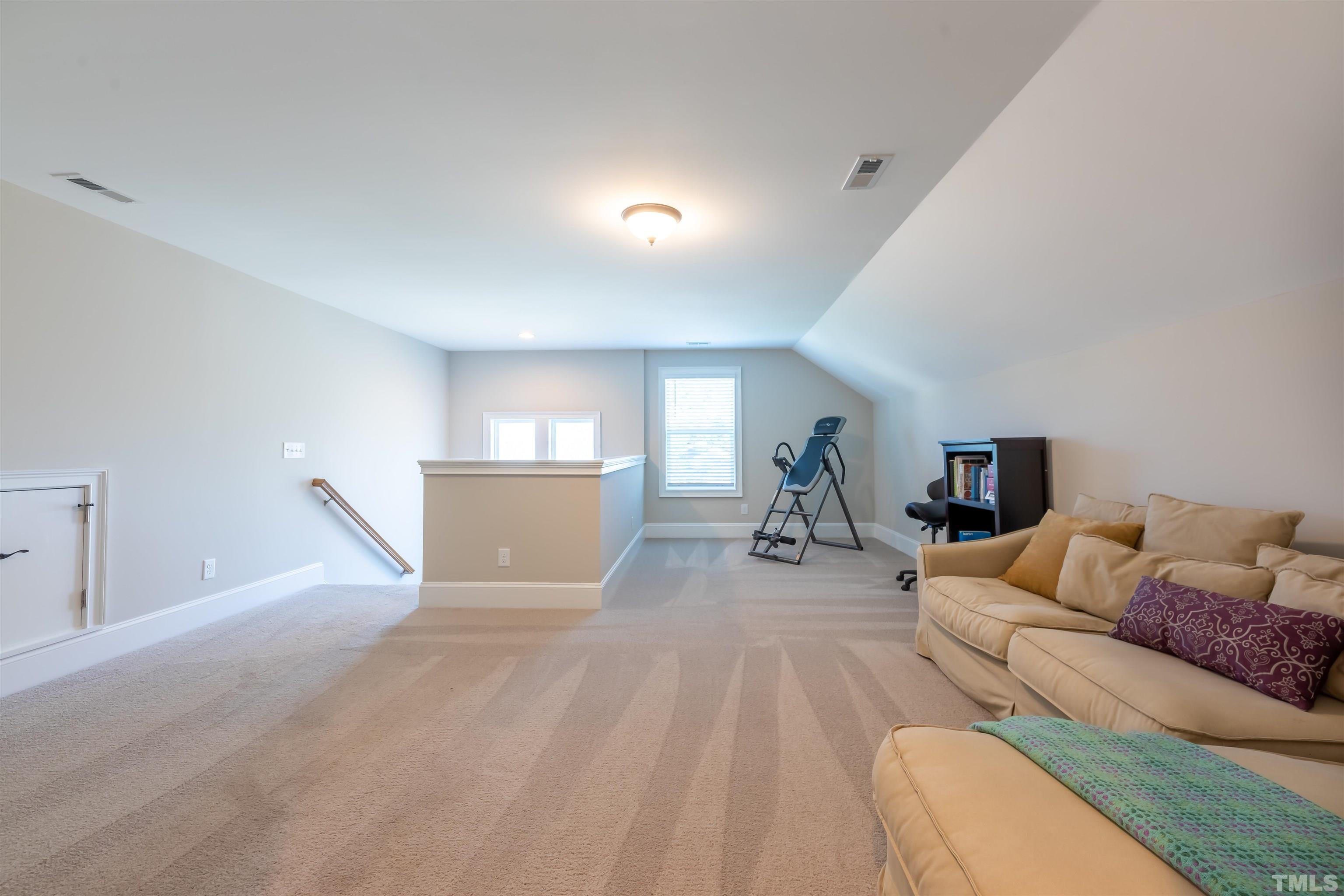 456 Adkins Ridge Road Rolesville, NC 27571 - Photo 24 of 38 a living room with furniture and a wooden floor